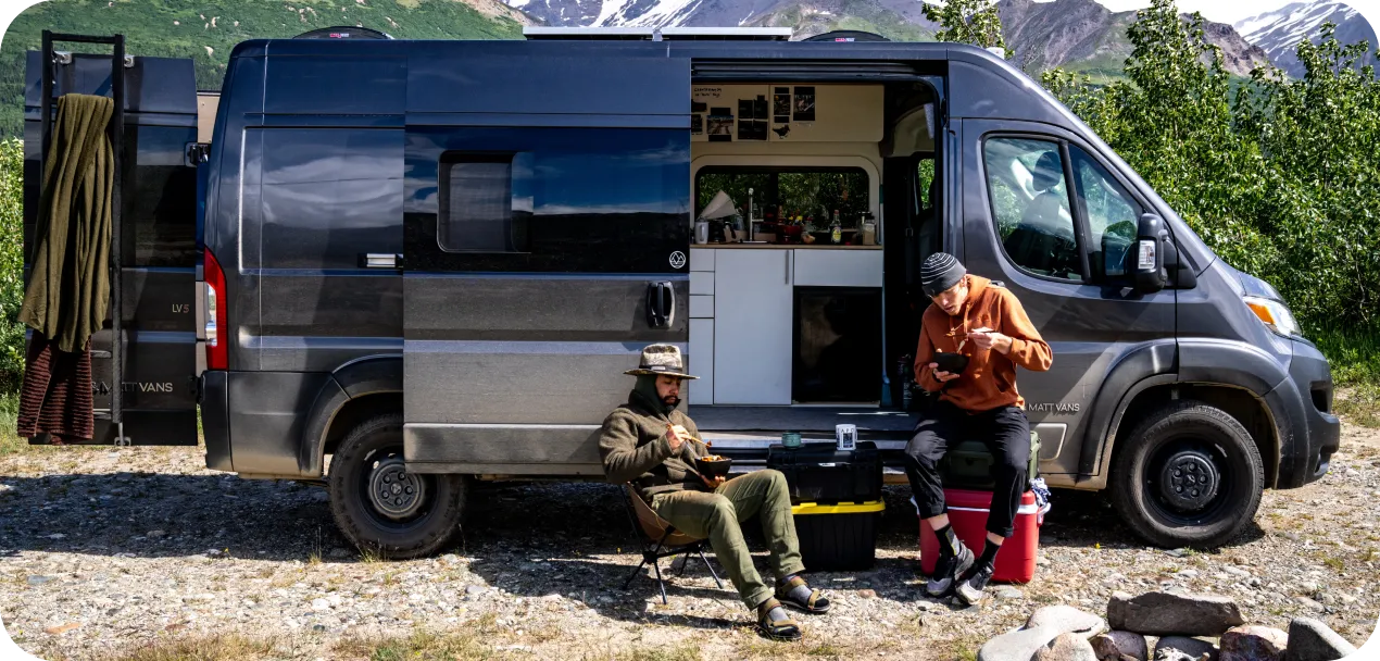 DM Van owners gathered with their vans at a mountain campsite